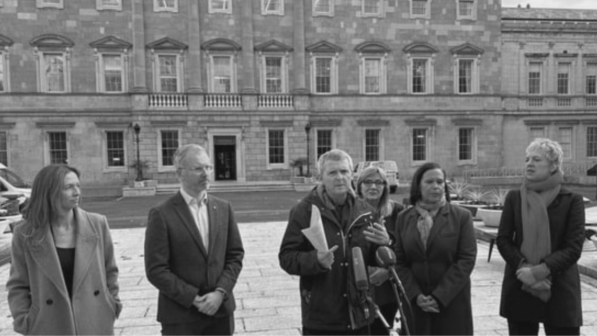 Richard Boyd Barrett Speaking For the Left Opposition in front of the Dail flanked by party leaders and Sen Frances Black.