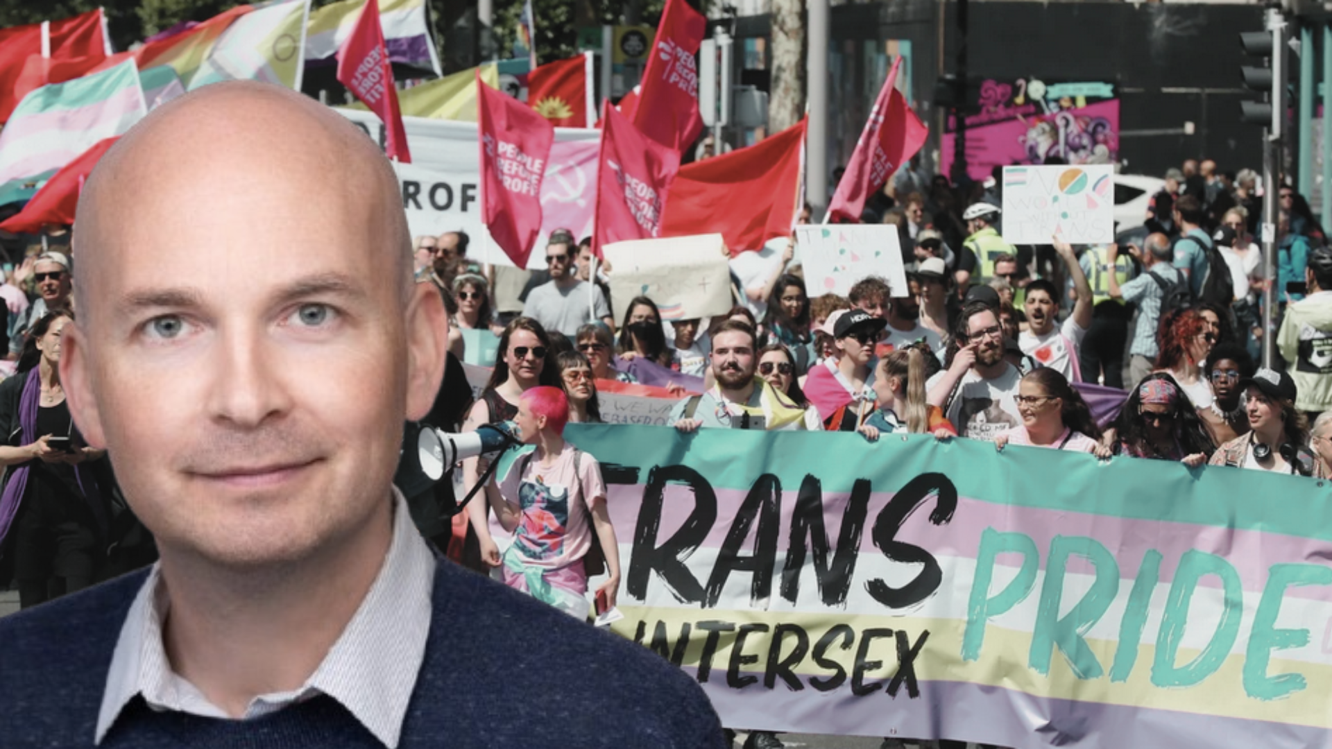 Paul Murphy in front of an image of the recent Trans and Intersex Pride March.