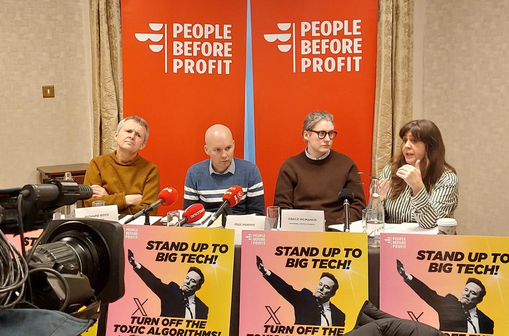PBP TDs Richard Boyd Barrett and Paul Murphy listen to Niamh McDonald of the Hope & Courage Collective at PBP's bill launch press event.