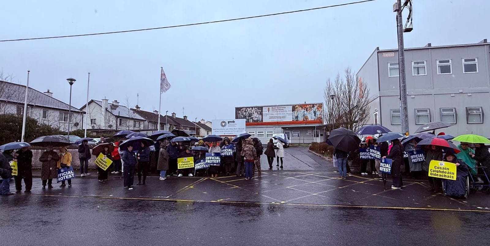 Dozens of protesters holding TUI 'Official Protest' Signs and Umbrellas in Athenry at the local GRETB centre.