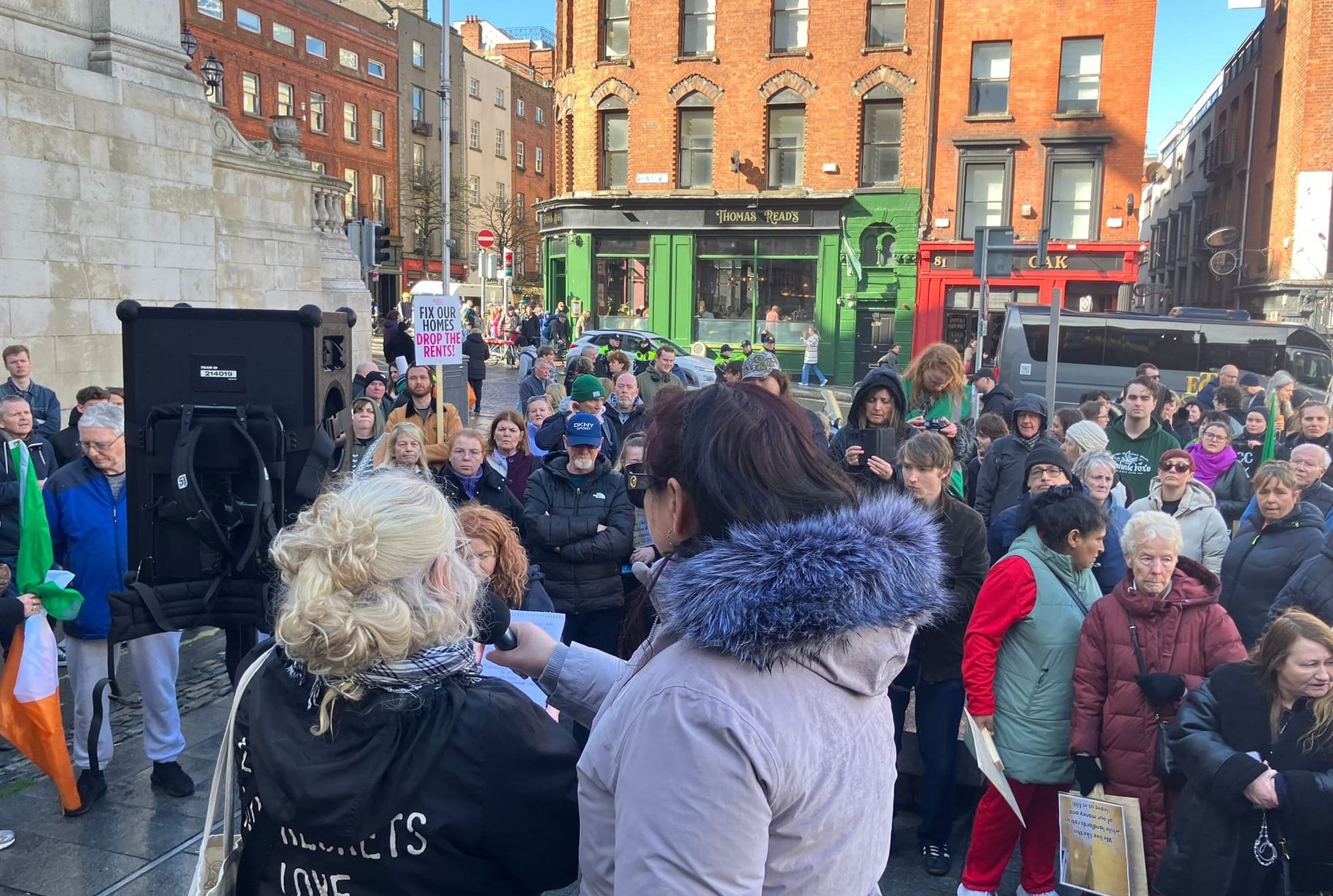 Marchers crowd in listening to speakers at Barnardos Square in Dublin at the end of the DROP THE RENT HIKES March on Saturday 28th. PBP Placard reads Fix Our Homes Drop the Rents. 
