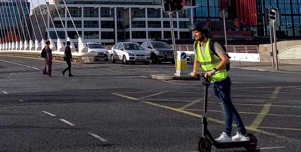 E-scooter rider at the Samuel Beckett bridge in Dublin.