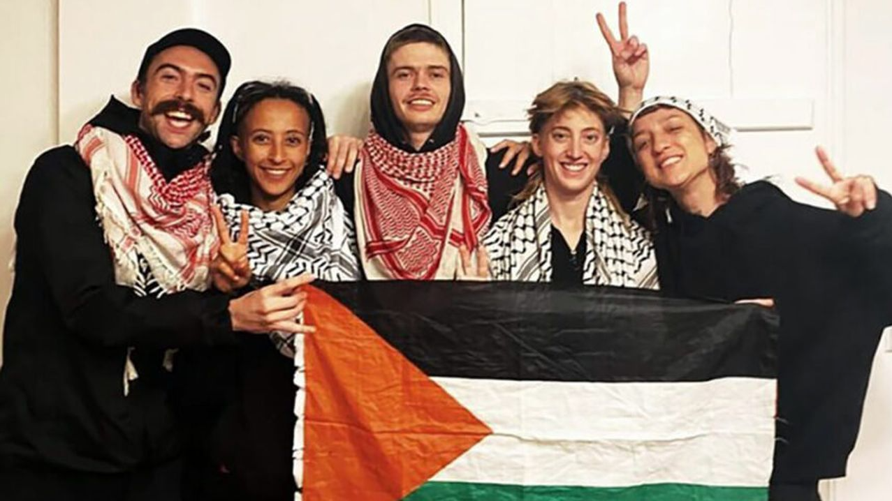 The Ulm 5 holding a Palestinian flag