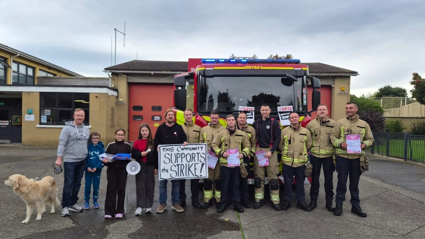 Community members standing with striking SIPTU members at Kilbarrack Fire Station in North Dublin