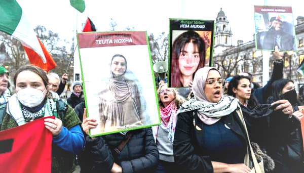 Hunger Striker Supporters marching in the UK holding images of Teuta Hoxha Hema Muraisi and others