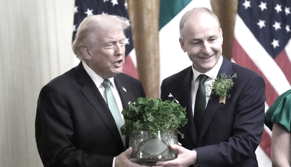 2026 Meeting of Government Taoiseach Micheál Martin and genocidal war criminal US President Donald Trump holding a crystal bowl of shamrock while wearing green ties.
