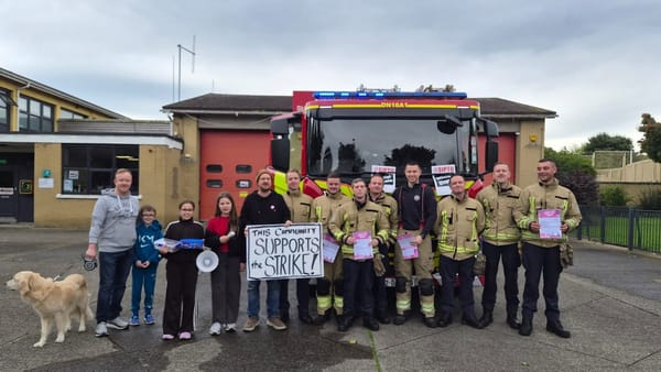 Community members standing with striking SIPTU members at Kilbarrack Fire Station in North Dublin. Sign saying This Community Supports The Strike!