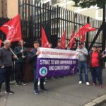 NIHE Strikers At The NI Housing Executive Offices in Belfast. Worker Banner Says: 'Strike to win improved pay and conditions'